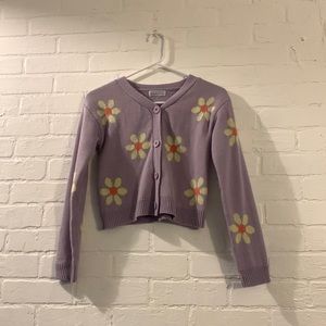 we are selling a White fawn purple flower cartigan with buttons you can undo